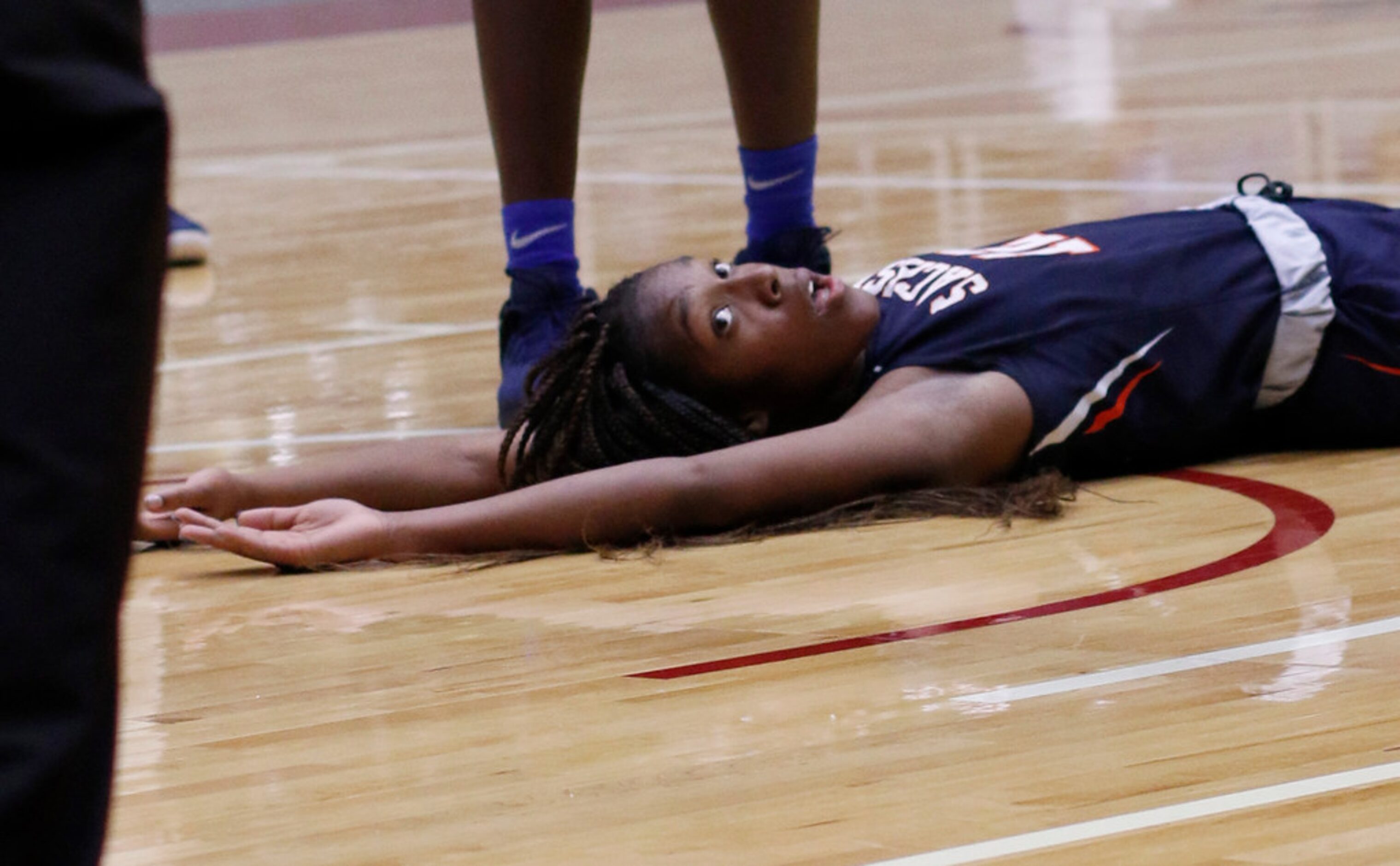 Sachse guard Tia Harvey (12) reacts after being charged with a blocking foul after a...