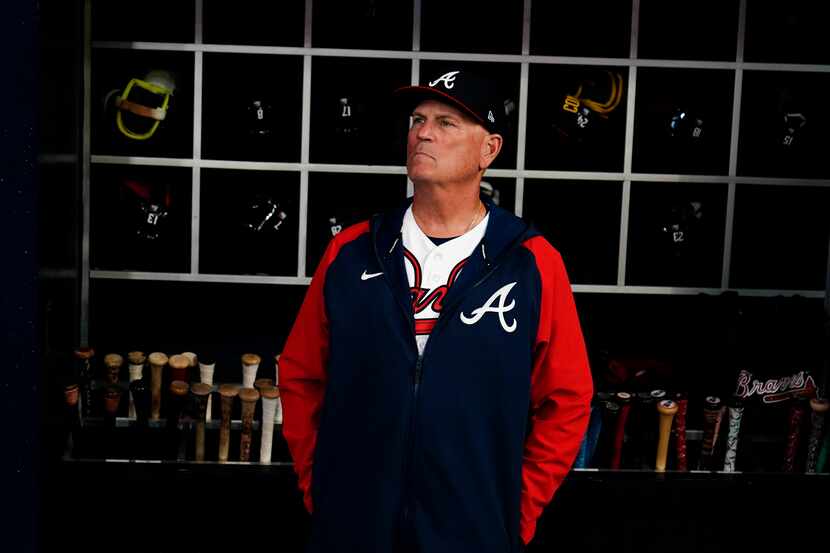 Atlanta Braves manager Brian Snitker stands in the dugout before Game 2 of baseball's...