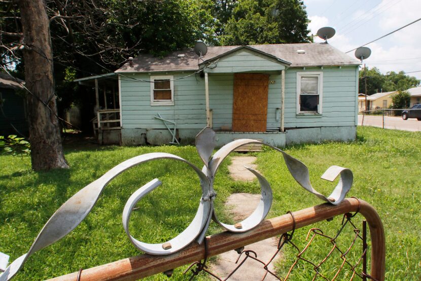 Vacant HMK properties located on McBroom Street in Dallas on Wednesday.