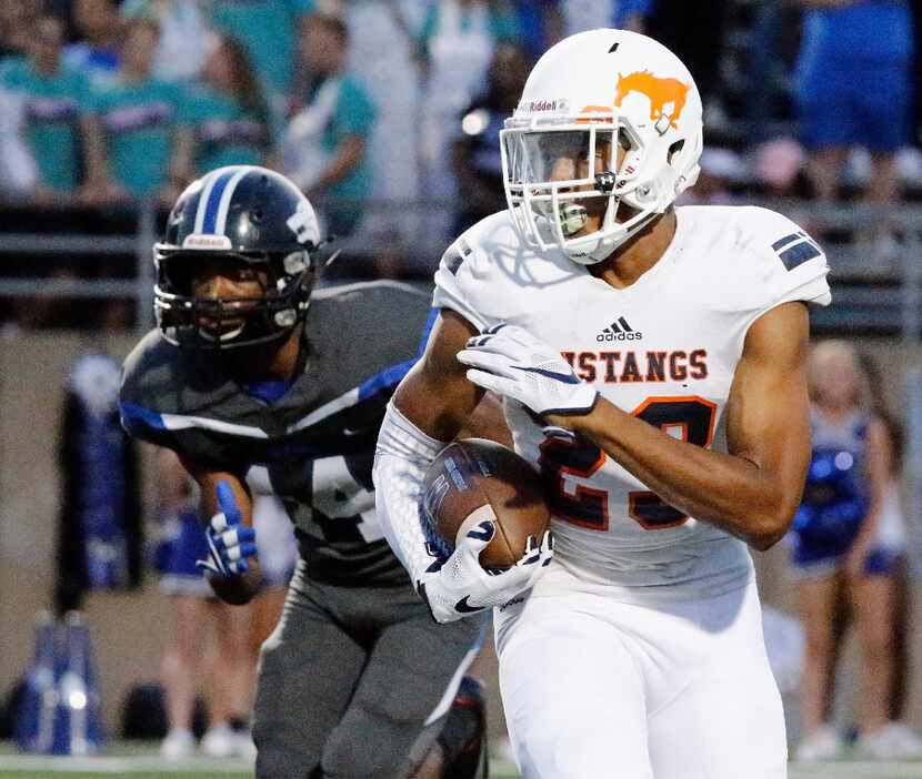 Sachse High School free safety Isaiah Humphries (23) returns a punt during the first half as...