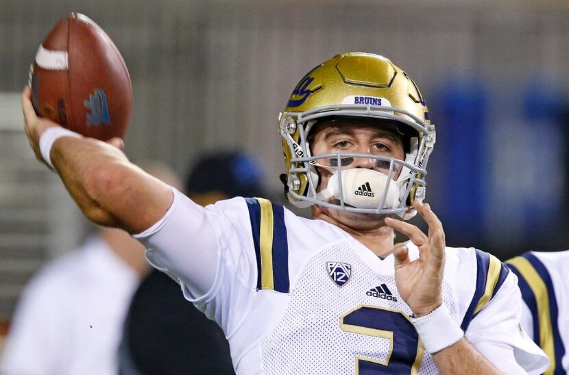 FILE - This Oct. 8, 2016 file photo shows UCLA quarterback Josh Rosen warming up prior to an...