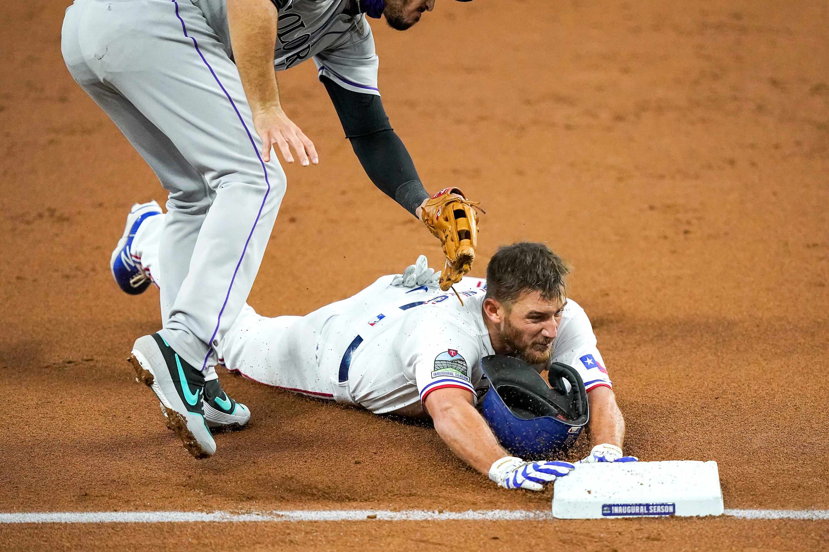 Texas Rangers catcher Jeff Mathis slides in head first for a triple under the tag from...