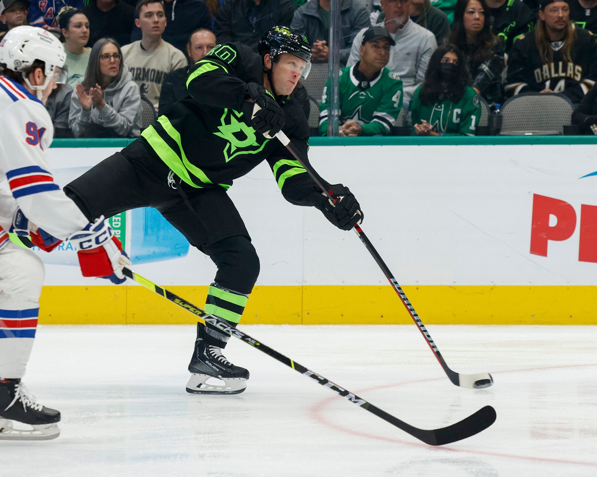 Dallas Stars defenseman Ryan Suter (20) takes a shot ahead of New York Rangers left wing...