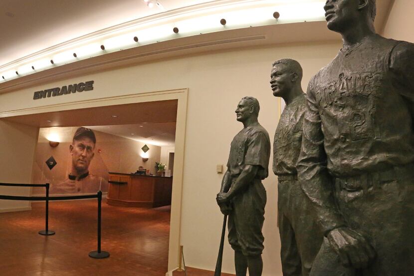 Statues of legendary ballplayers Roberto Clemente, Jackie Robinson, and Lou Gehrig, right to...
