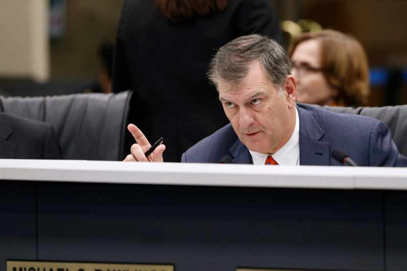 Dallas Mayor Mike Rawlings talks to the chief financial officer during a meeting about the...