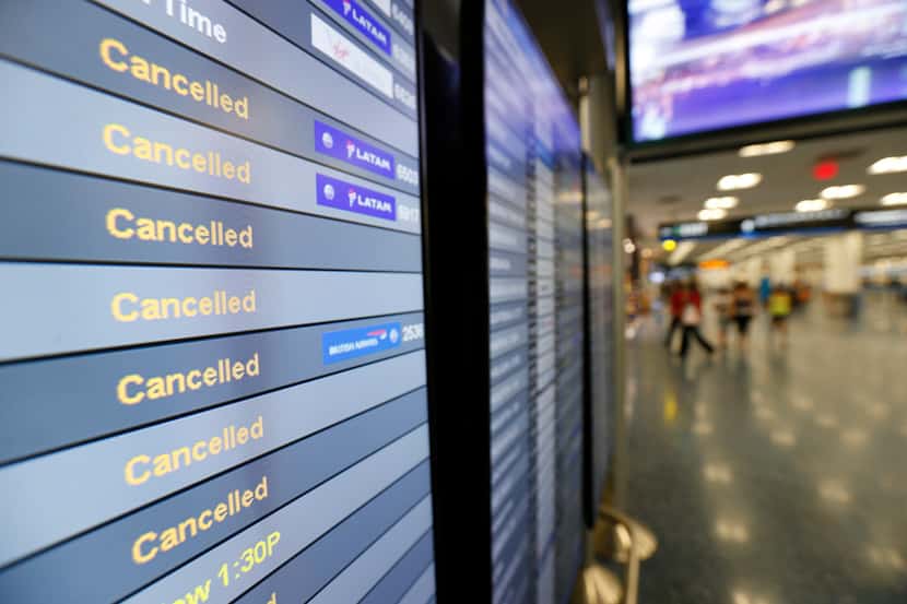 FILE - This Friday, Sept. 8, 2017, file photo, shows a monitor listing canceled flights at...