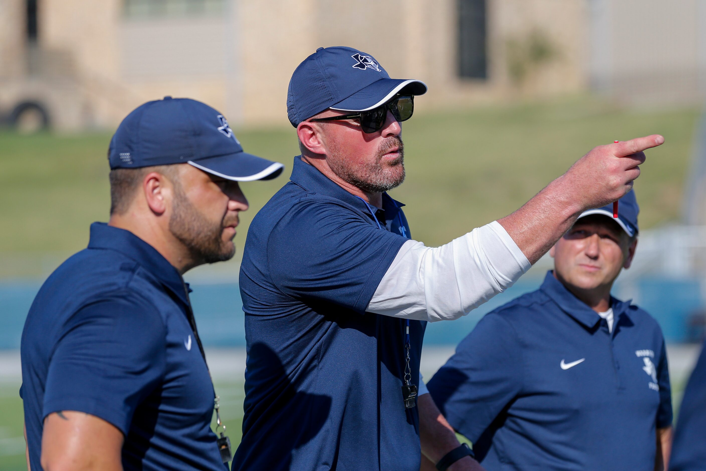 Argyle Liberty Christian head coach Jason Witten talks with the coaching staff during a...