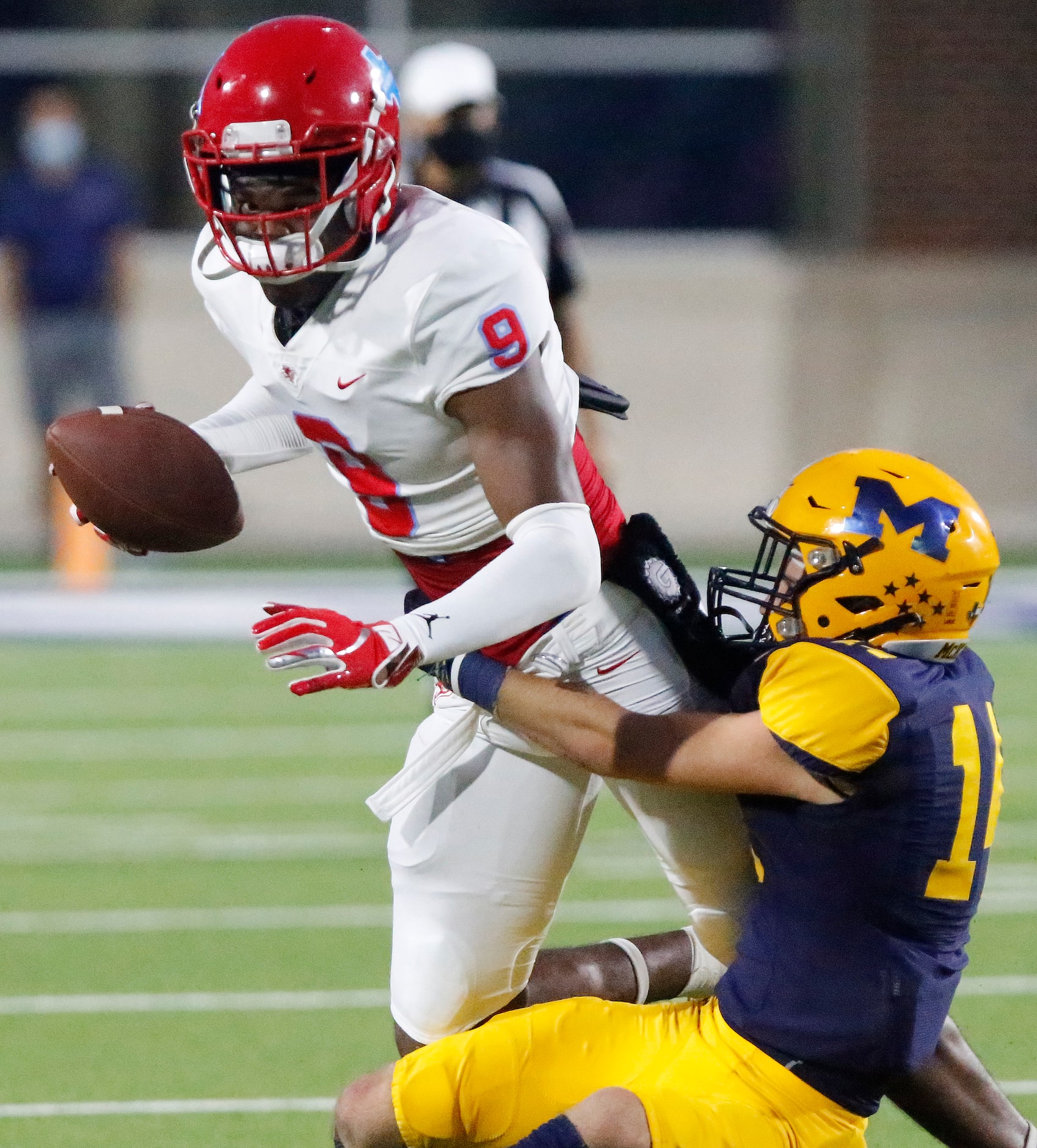 Skyline High School quarterback Darryl Richardson (9) is brought down by  McKinney High...