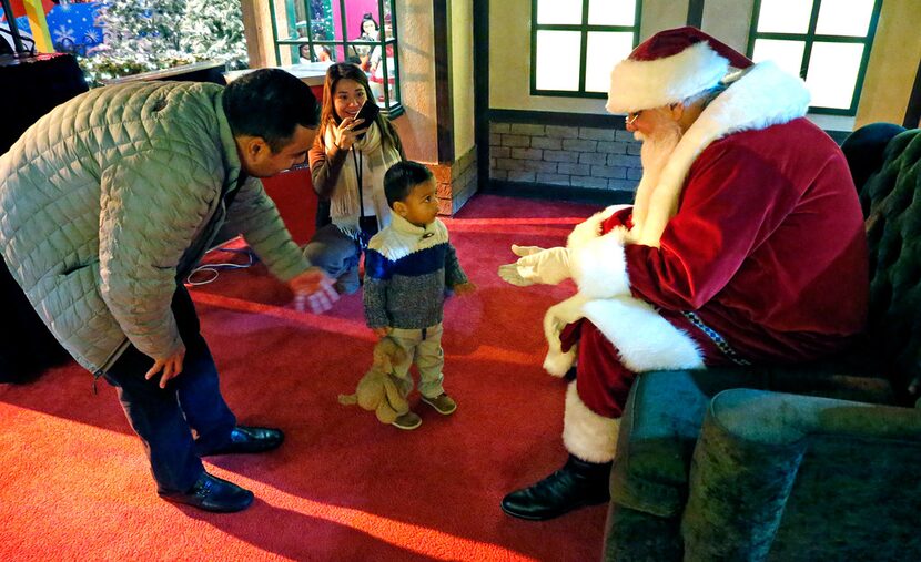 Noah Cortes, 2, of Dallas, is encouraged by his father, Israel, while his mother, Marcela,...