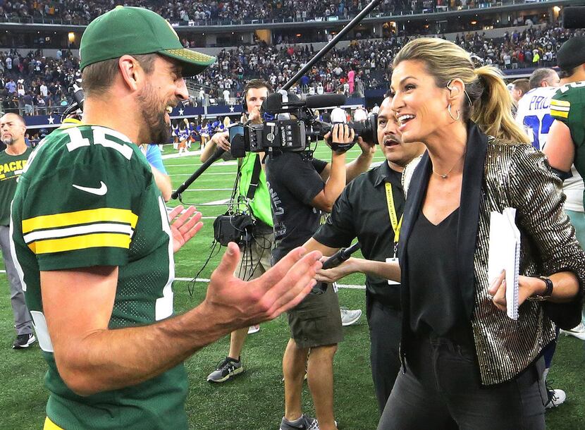 Green Bay Packers quarterback Aaron Rodgers (12) talks with sideline reporter Erin Andrews...