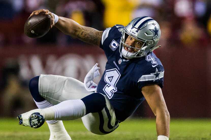 Dallas Cowboys quarterback Dak Prescott (4) recovers after tripping during the fourth...