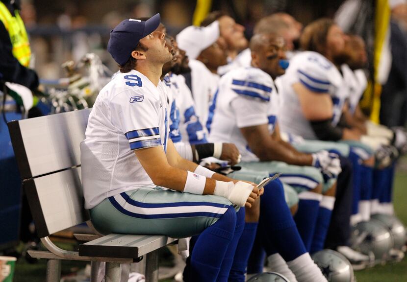 Dallas quarter back Tony Romo (9) watches from the bench during the first half of a NFL...