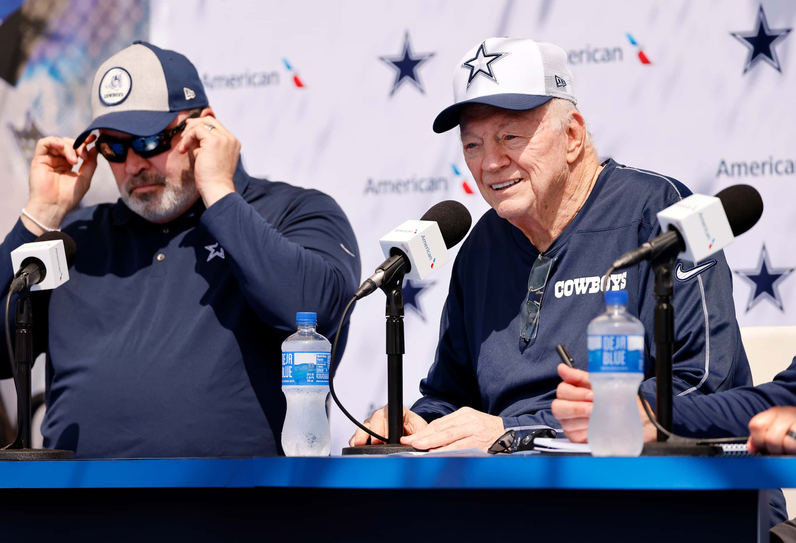 Dallas Cowboys owner Jerry Jones addresses questions from the media alongside his head coach...