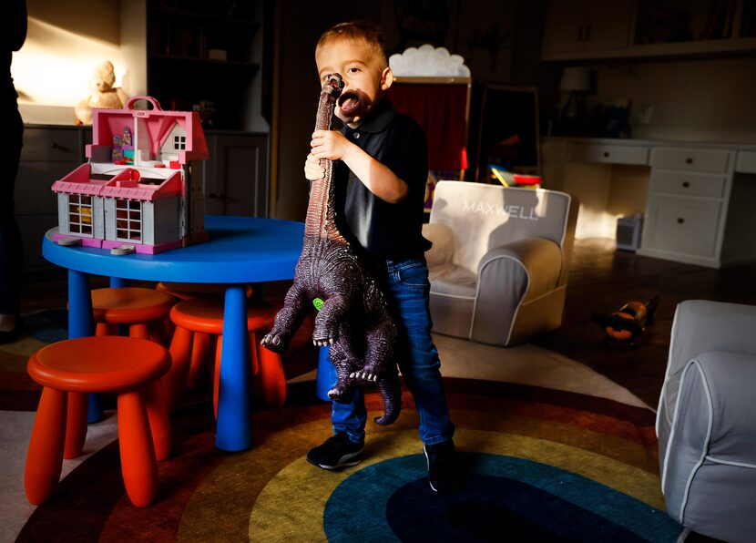 Maxwell, called Maxie by his parents and Maxie Boy by twin sister Riley, shows off his toy...