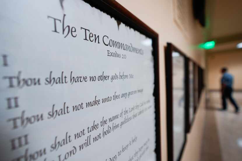 A copy of the Ten Commandments is posted along with other historical documents in a hallway...