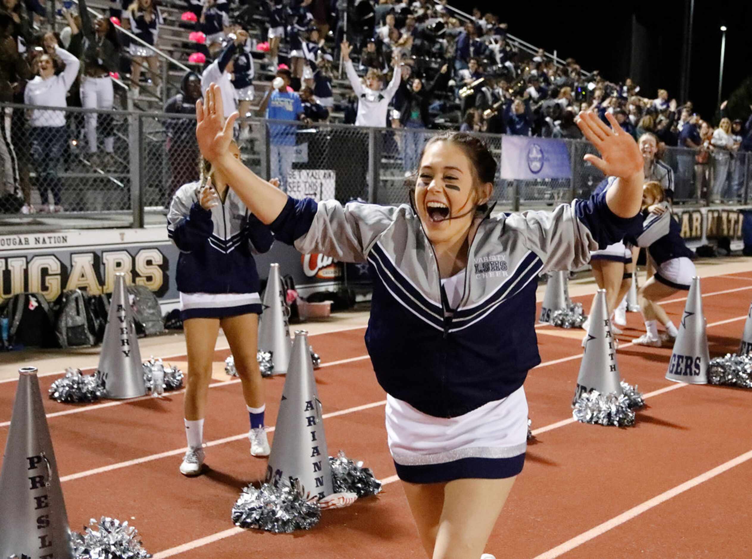 Lone Star High School cheerleader Faith Brown sprints down the sideline after the go ahead...