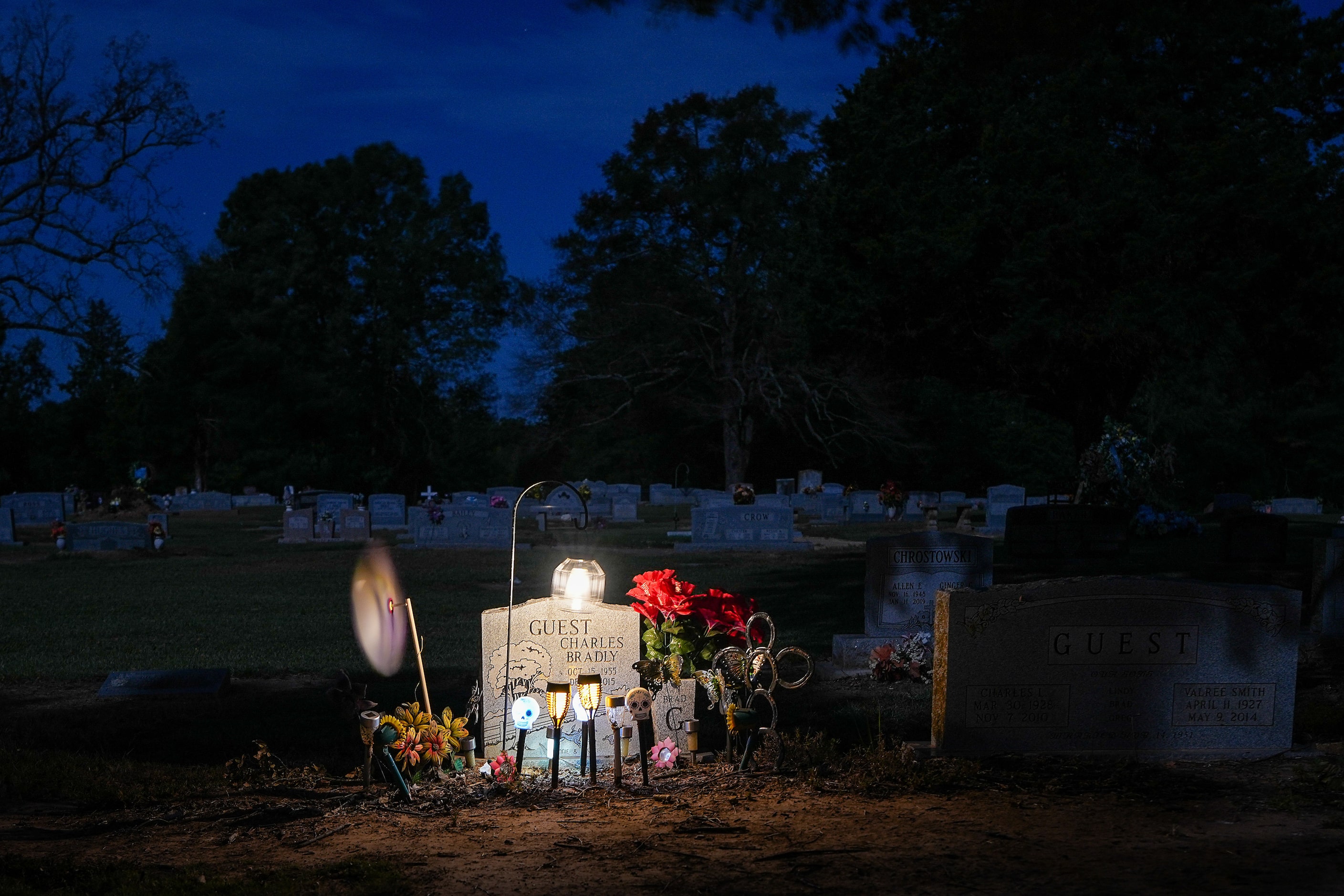 The grave of  Charles Bradly Guest is illuminated as night falls on the Cuthand Cemetery on...