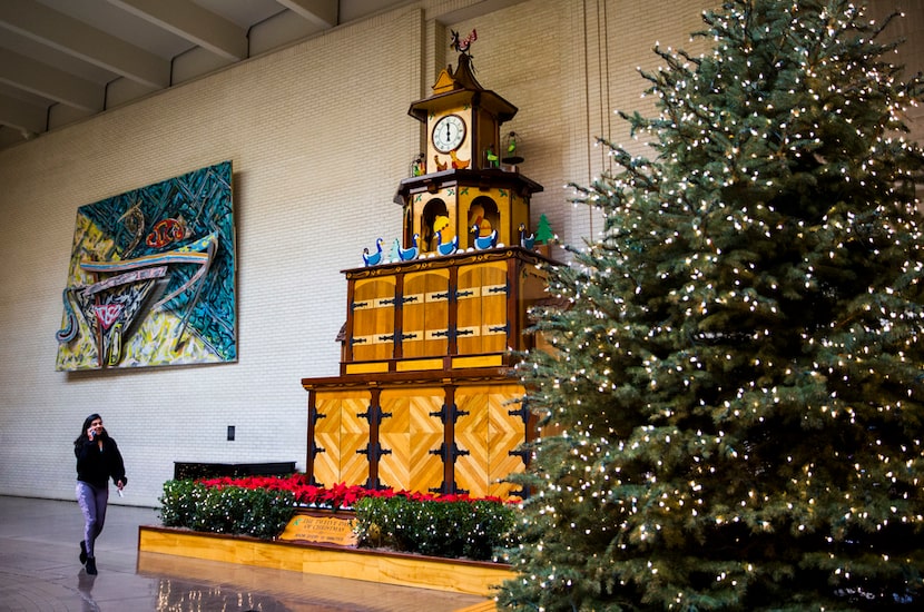 The Twelve Days of Christmas wooden performance sculpture is among Christmas decorations in...