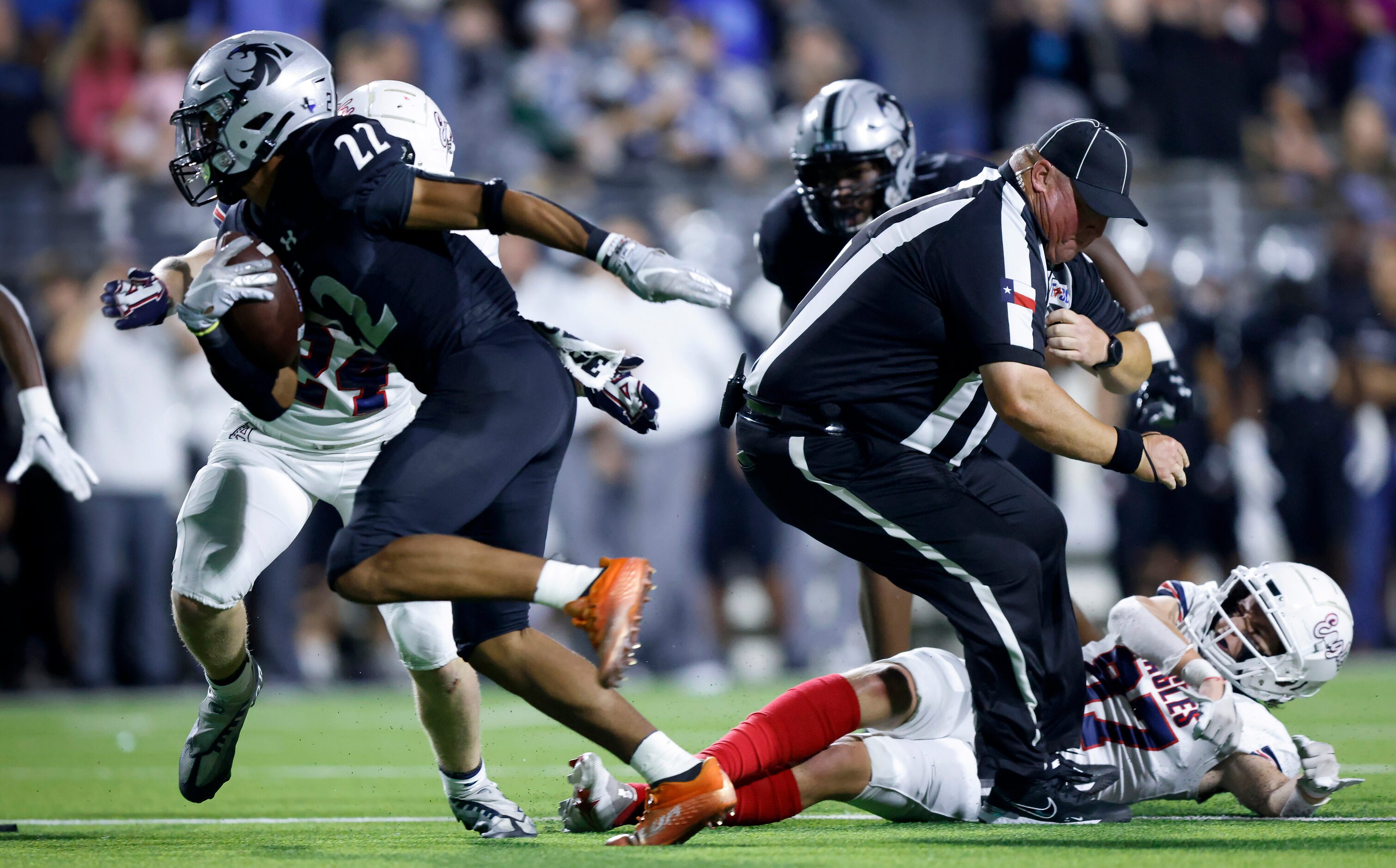 Denton Guyer punt returner Peyton Bowen (22) broke several tackles, including this one by...