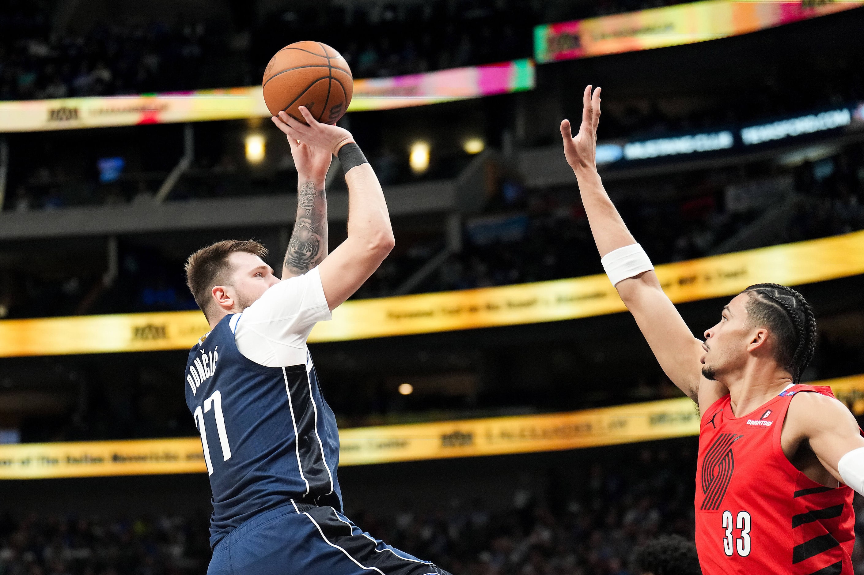 Dallas Mavericks guard Luka Doncic (77) shoots over Portland Trail Blazers forward Toumani...