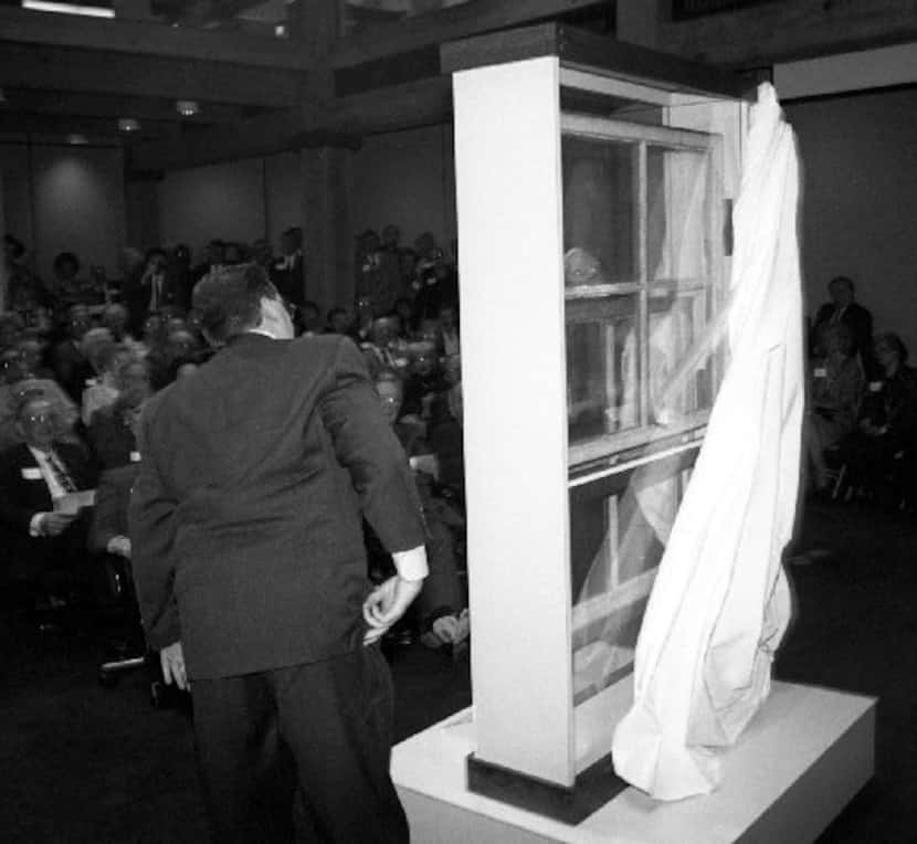 Jeff West and Caruth Byrd, barely visible through the window, unveil the Sniper's Perch ...