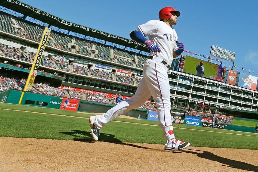 Texas Rangers third baseman Joey Gallo (13) heads to the dugout after homering in the sixth...