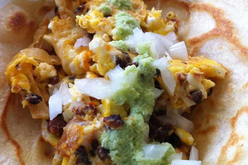 This breakfast taco at Salsa Limon has chorizo, egg and cheese with raw onion and jalape o...