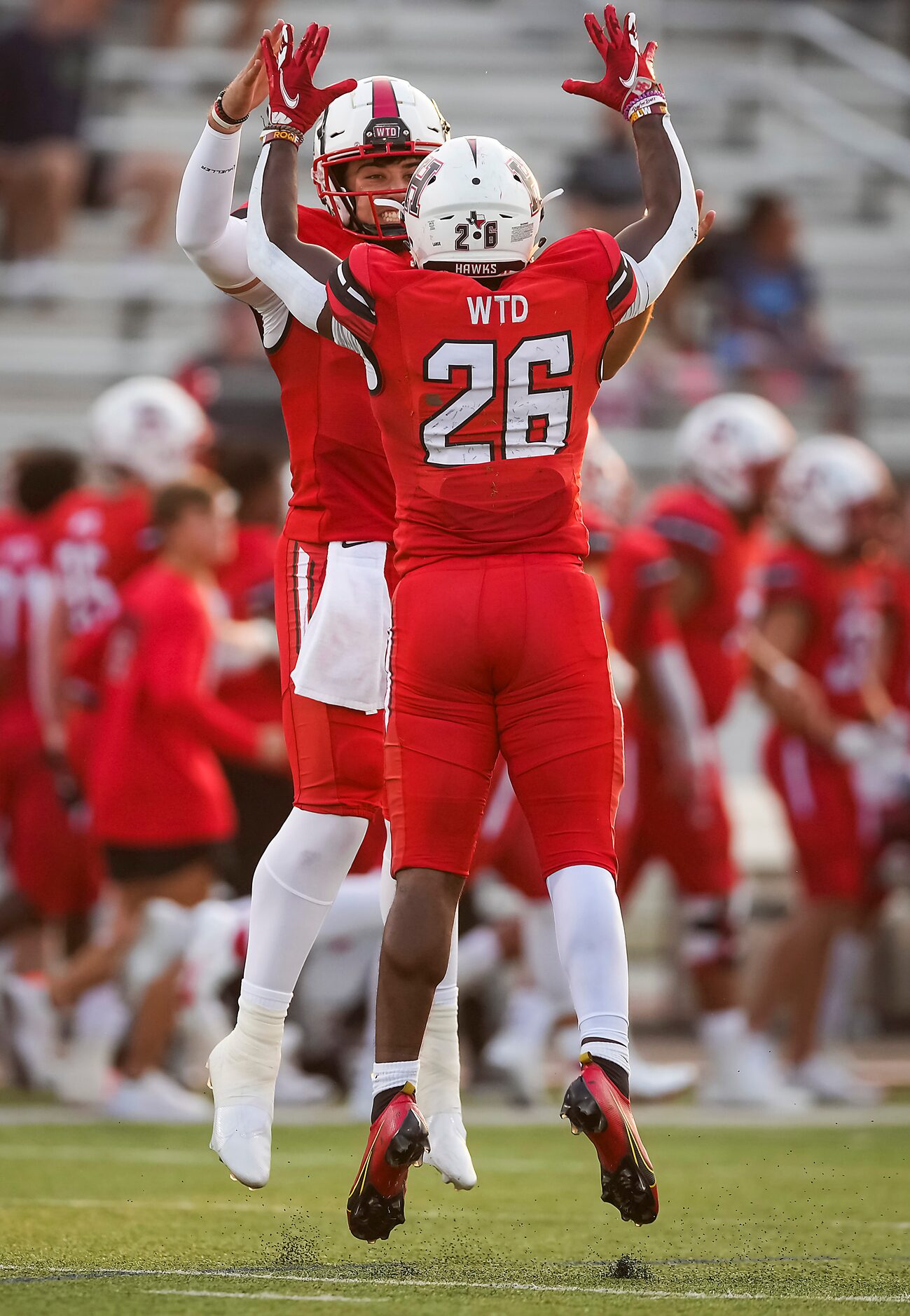 Rockwall-Heath quarterback Josh Hoover celebrates with running back Zach Evans (26) after...