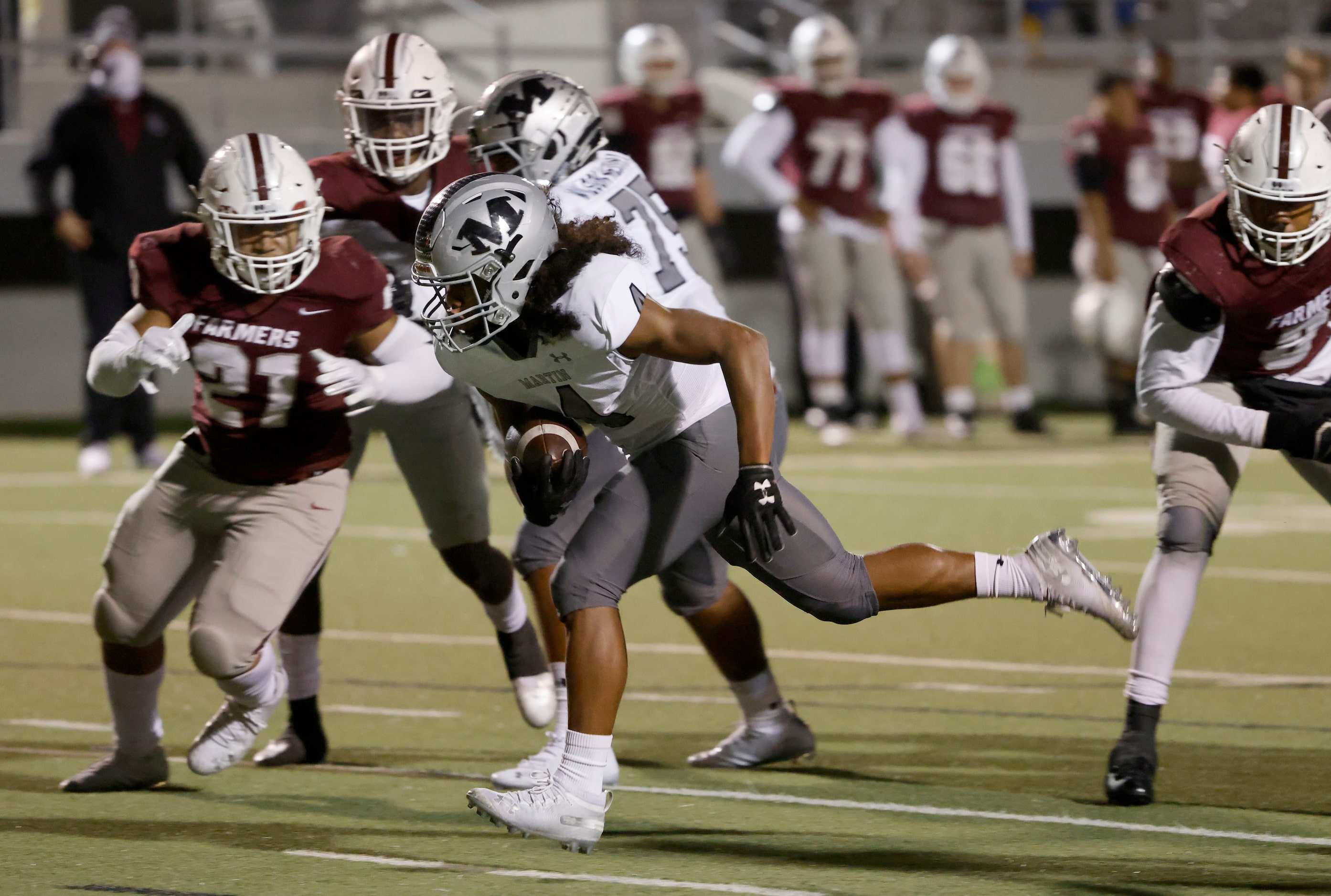 Arlington Martin running back  Zaire Burrow (4) runs through the Lewisville line to score a...