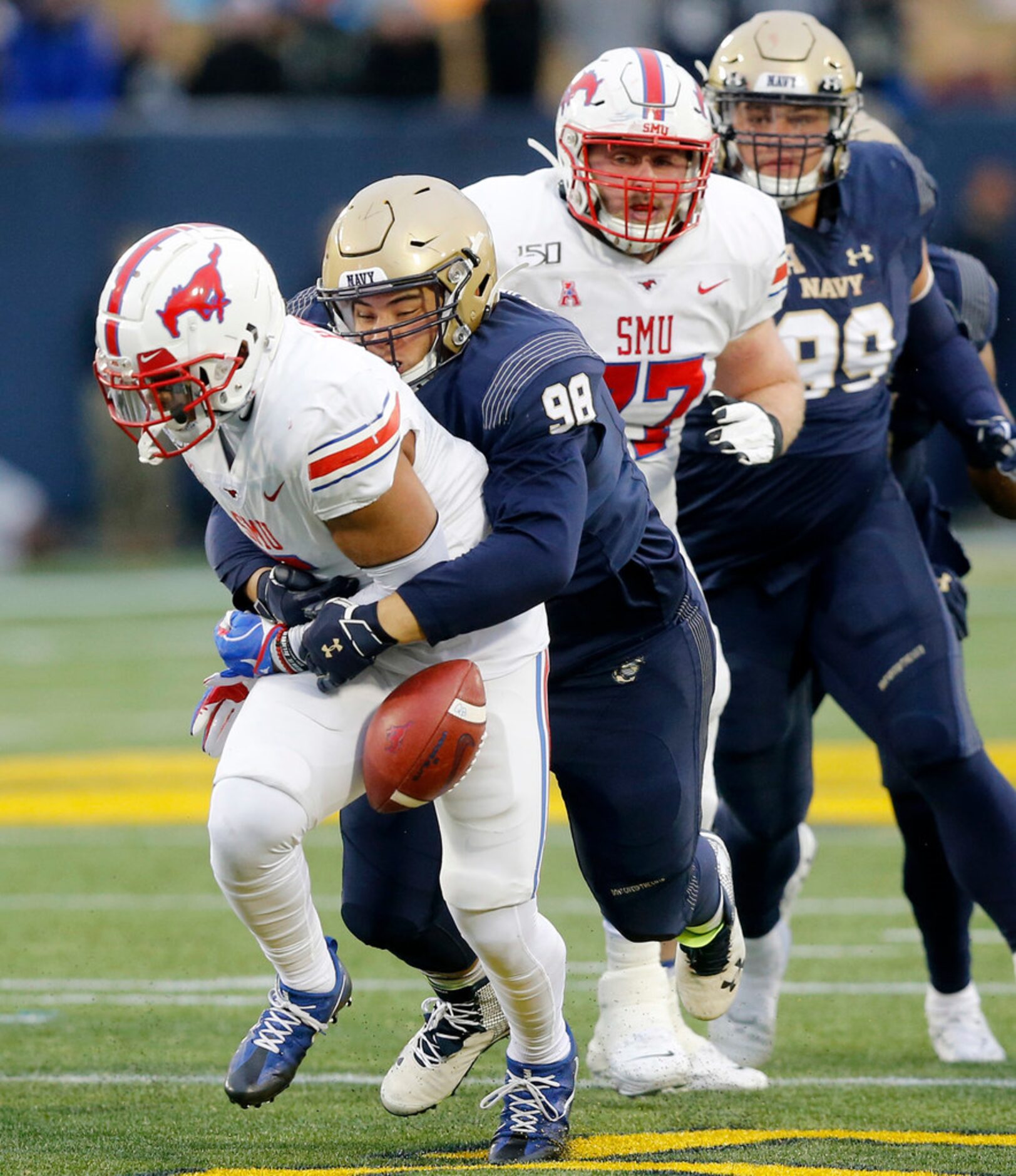 Navy Midshipmen defensive lineman Mike Flowers (98) forces Southern Methodist Mustangs...