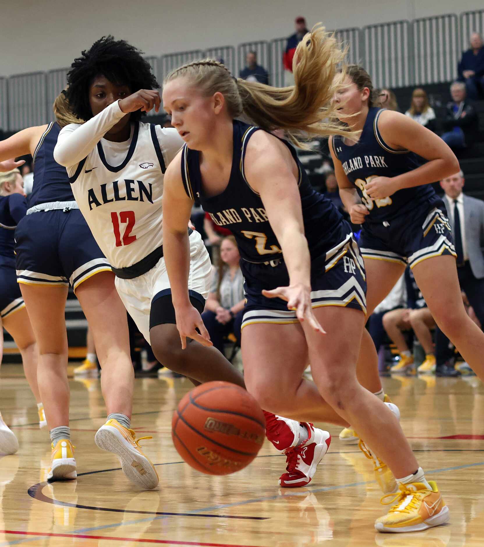 Highland Park guard Tyler Corwin (2) drives the baseline as she is guarded by Allen's...