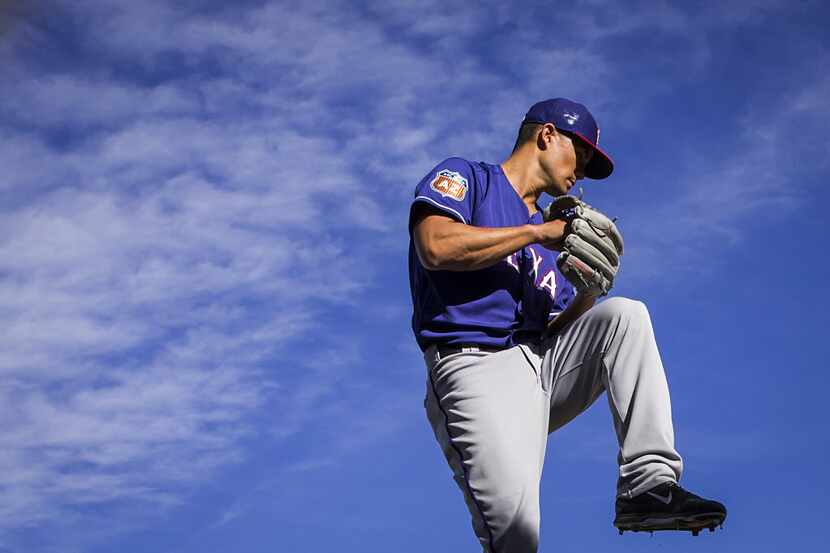 Texas Rangers pitcher Jeremy Guthrie throws in the bullpen during a spring training workout...