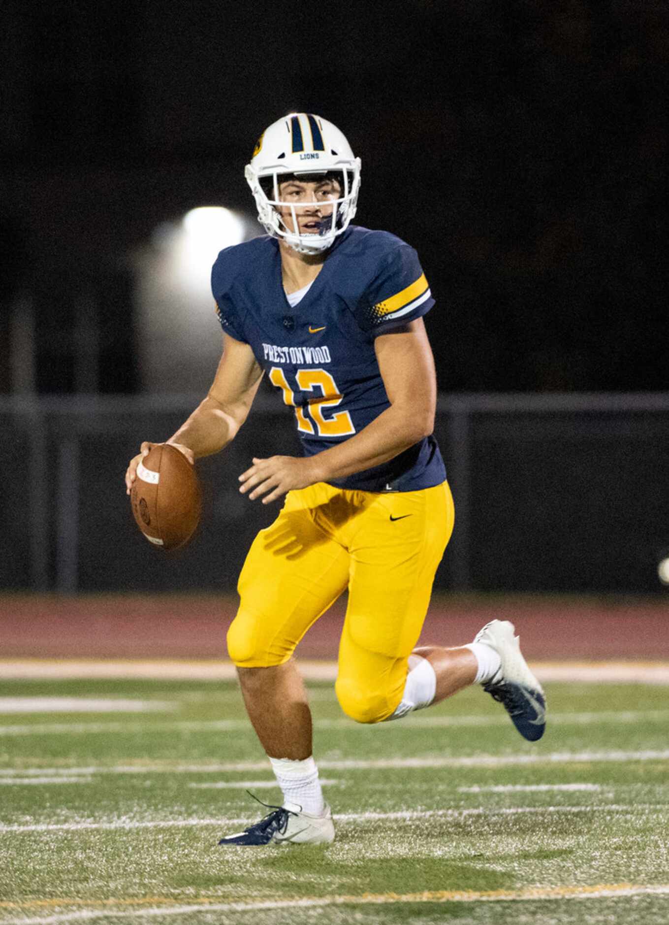 Plano Prestonwood Christian senior quarterback Jacob Switzer (12) rolls out to pass against...