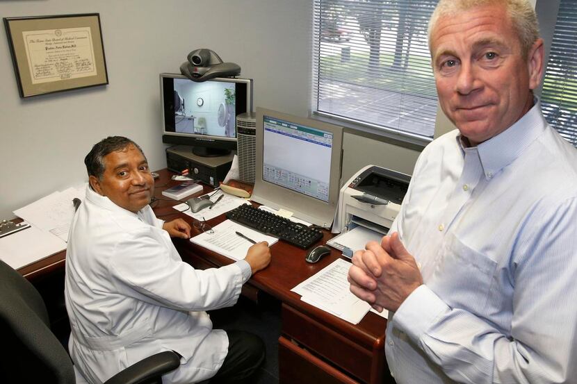 
Dr. Pradan A. Nathan (left) and Dr. Owen Murray work with inmates using video streaming at...
