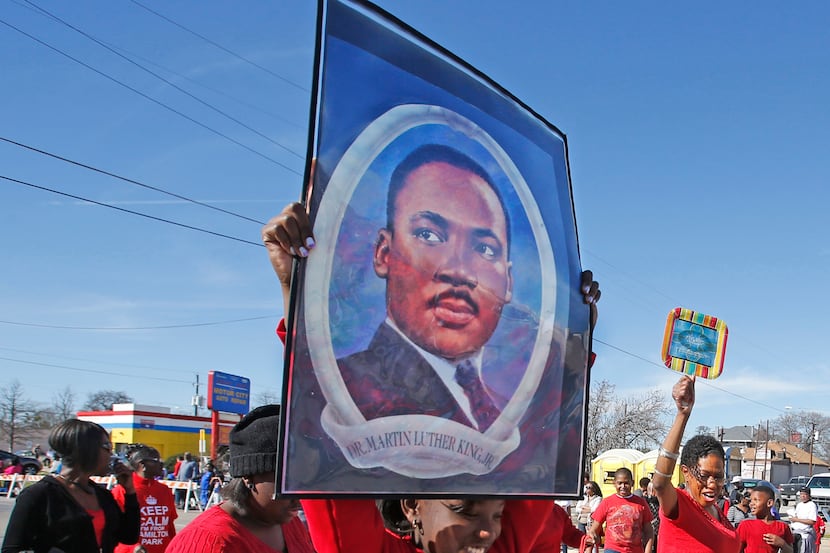 Cortlynne Gaines, 11, of New Mt. Zion Baptist Church, carries a large portrait of Dr. King...