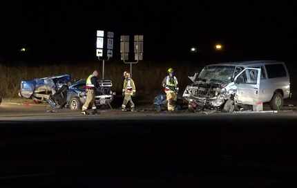 Wylie firefighters clean up around the wreckage from a two-vehicle crash, on Wednesday Nov....