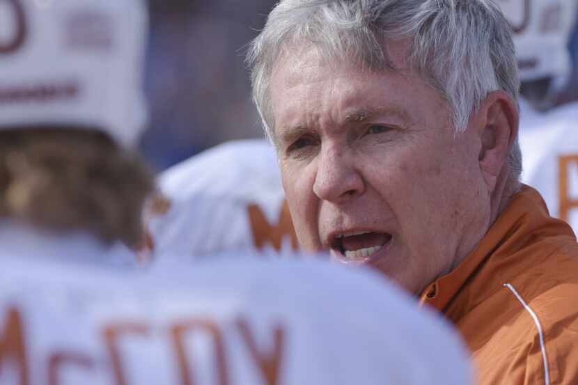 Texas head coach Mack Brown talks to quarterback Case McCoy (6) before sending him into the...