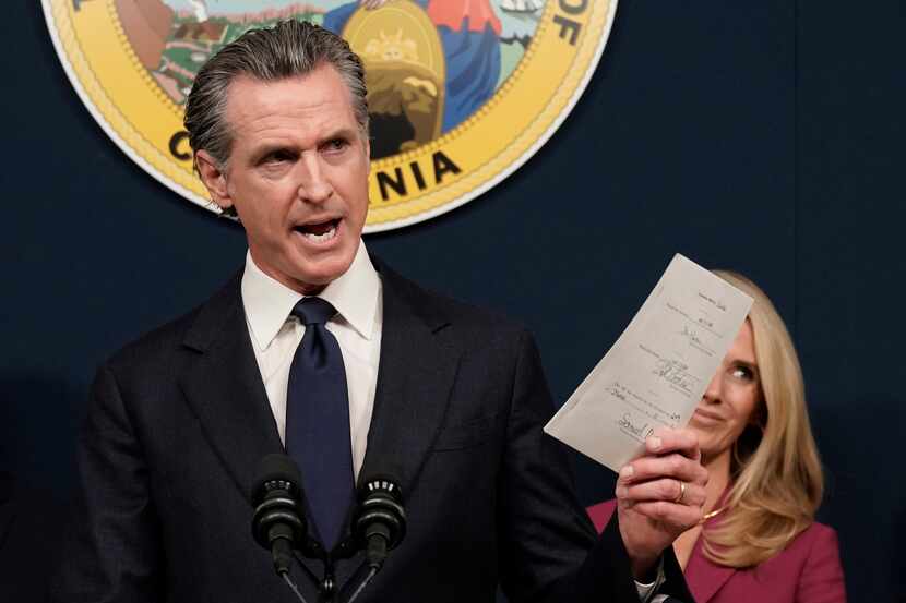 FILE - California Gov. Gavin Newsom displays a bill he signed that shields abortion...