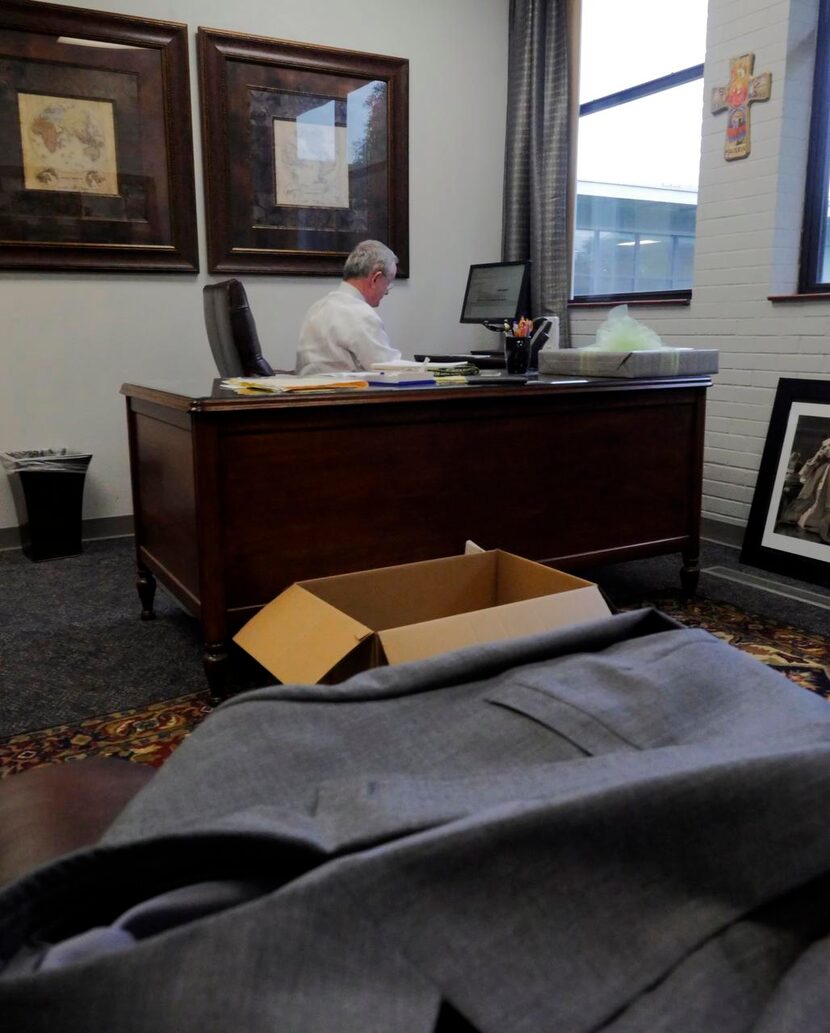 
Leyden works in his office. He has started to pack up his office and has a filled eight...