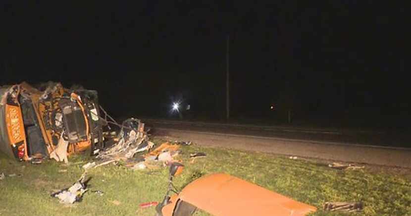 The wreckage of a Mount Pleasant ISD bus lies alongside U.S. Highway 271 following a crash...