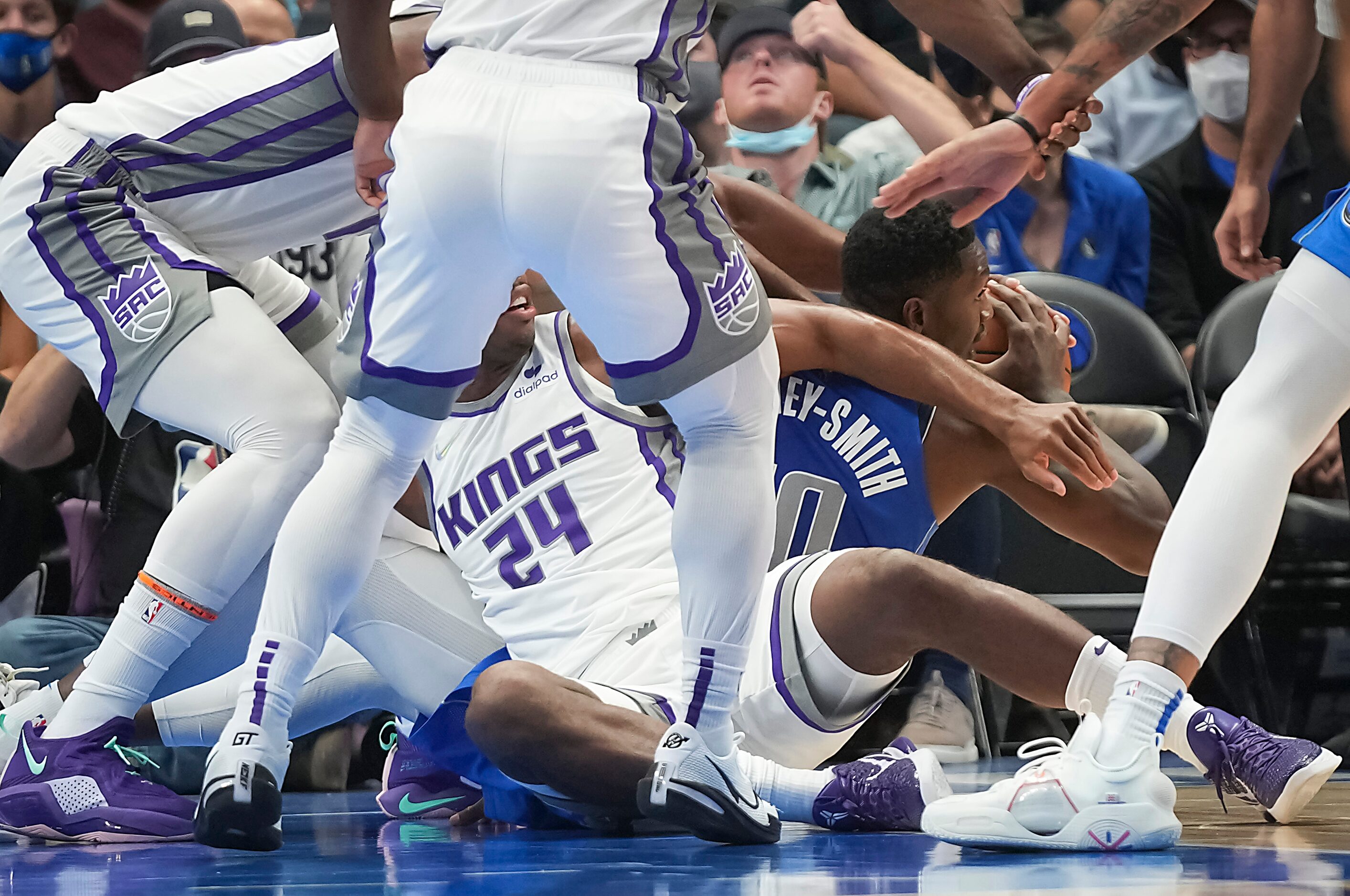 Dallas Mavericks forward Dorian Finney-Smith (10) goes to the floor for a loose ball against...