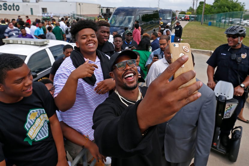 Denver Broncos linebacker Von Miller takes a selfie with fans during Von Miller Day at...