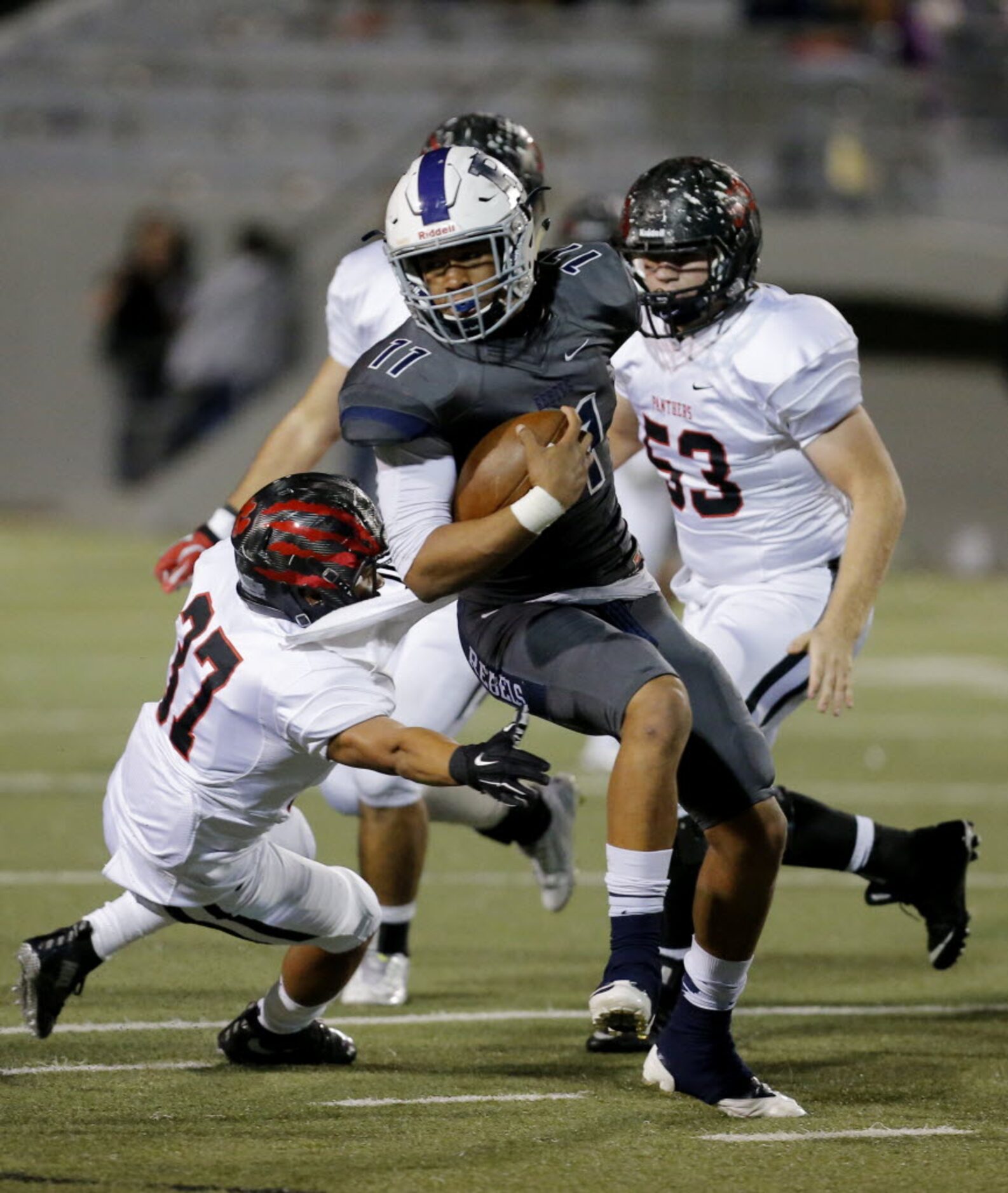 Richland's Nate Graves (11) looks for room against the Colleyville Heritage defense during...