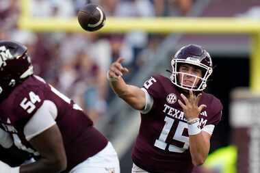 Texas A&M quarterback Conner Weigman (15) pass down field for a completion against New...