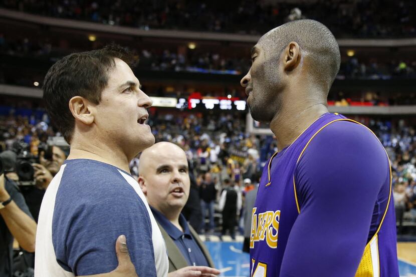Dallas Mavericks owner Mark Cuban talks with Los Angeles Lakers forward Kobe Bryant (24)...