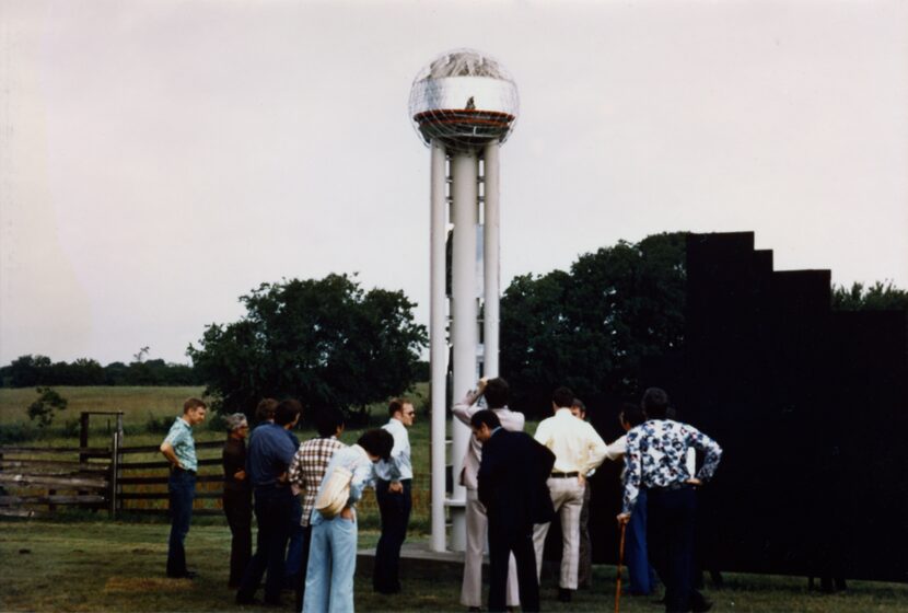 Reunion Tower developers Ray Hunt (center, with sunglasses) and John Scovell (right, back to...