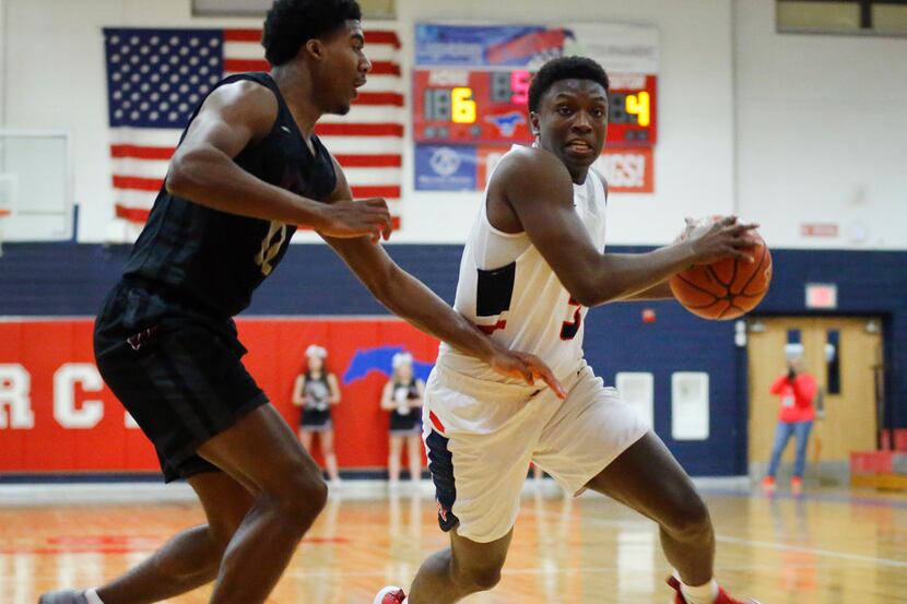 Allen's Isaiah Stevens (3) drives on Wylie's Cam Wells (12) in the first half of their...