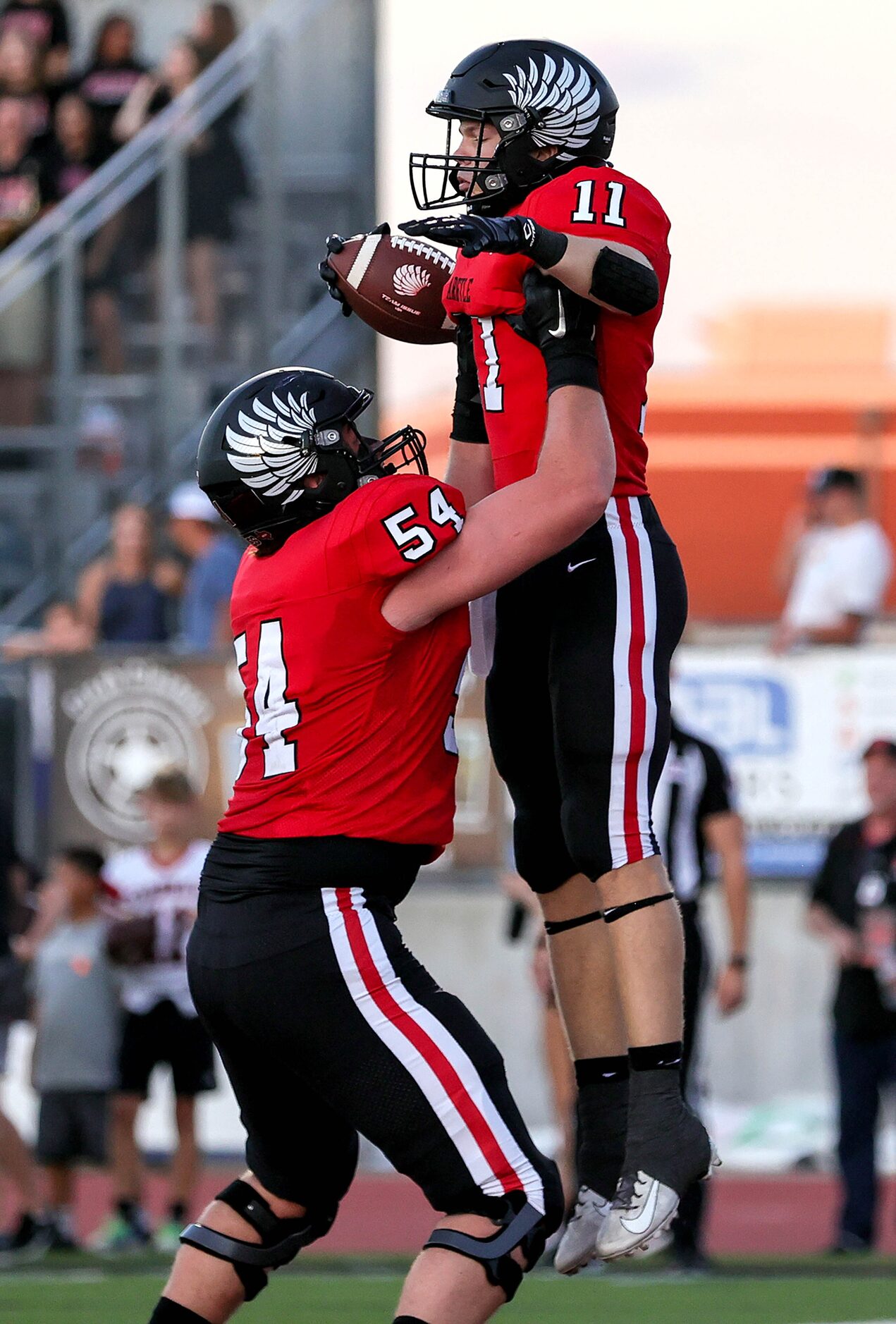 Argyle running back RJ Bunnell (11) celebrates with Wes Tucker (54) after scoring a...