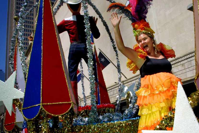  Dallas Morning News columnist Jacquielynn Floyd waves while riding on the Big Tex float in...