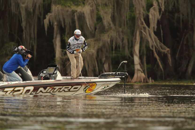 Rick Clunn, 69, is filmed fighting a large bass during the Bassmaster Elite Series...